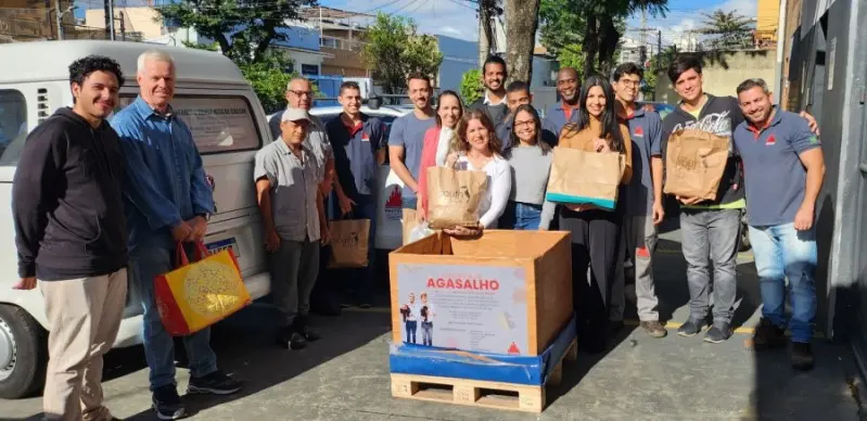 A group of different people with a woodbox in front of them